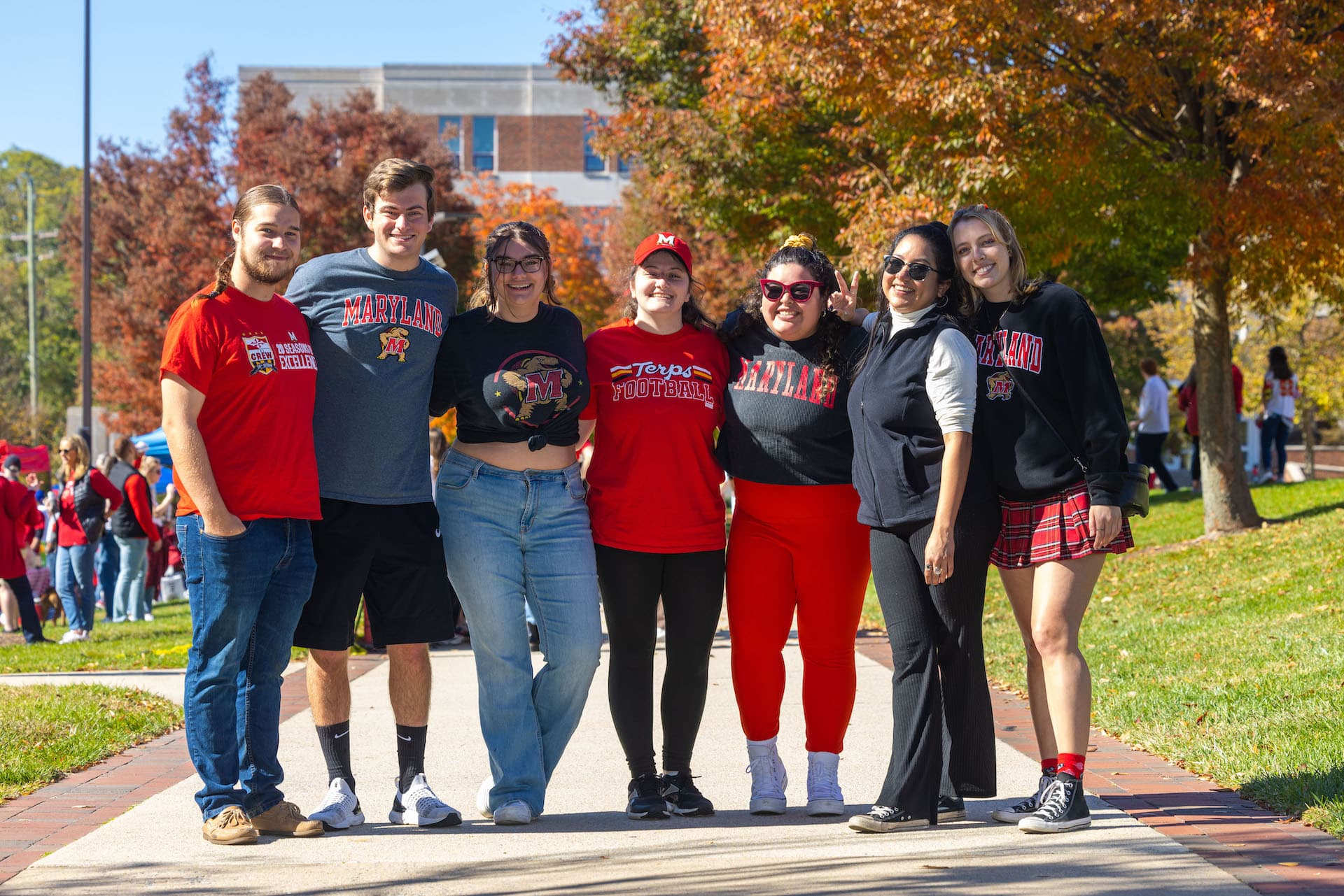 Students pose for a photo at a Homecoming tailgate.