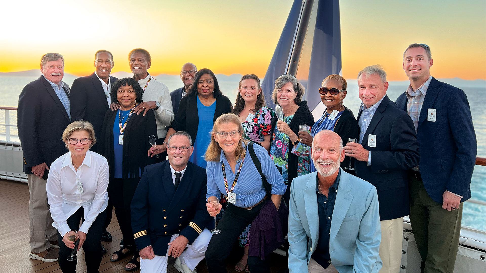 group poses for photo on boat