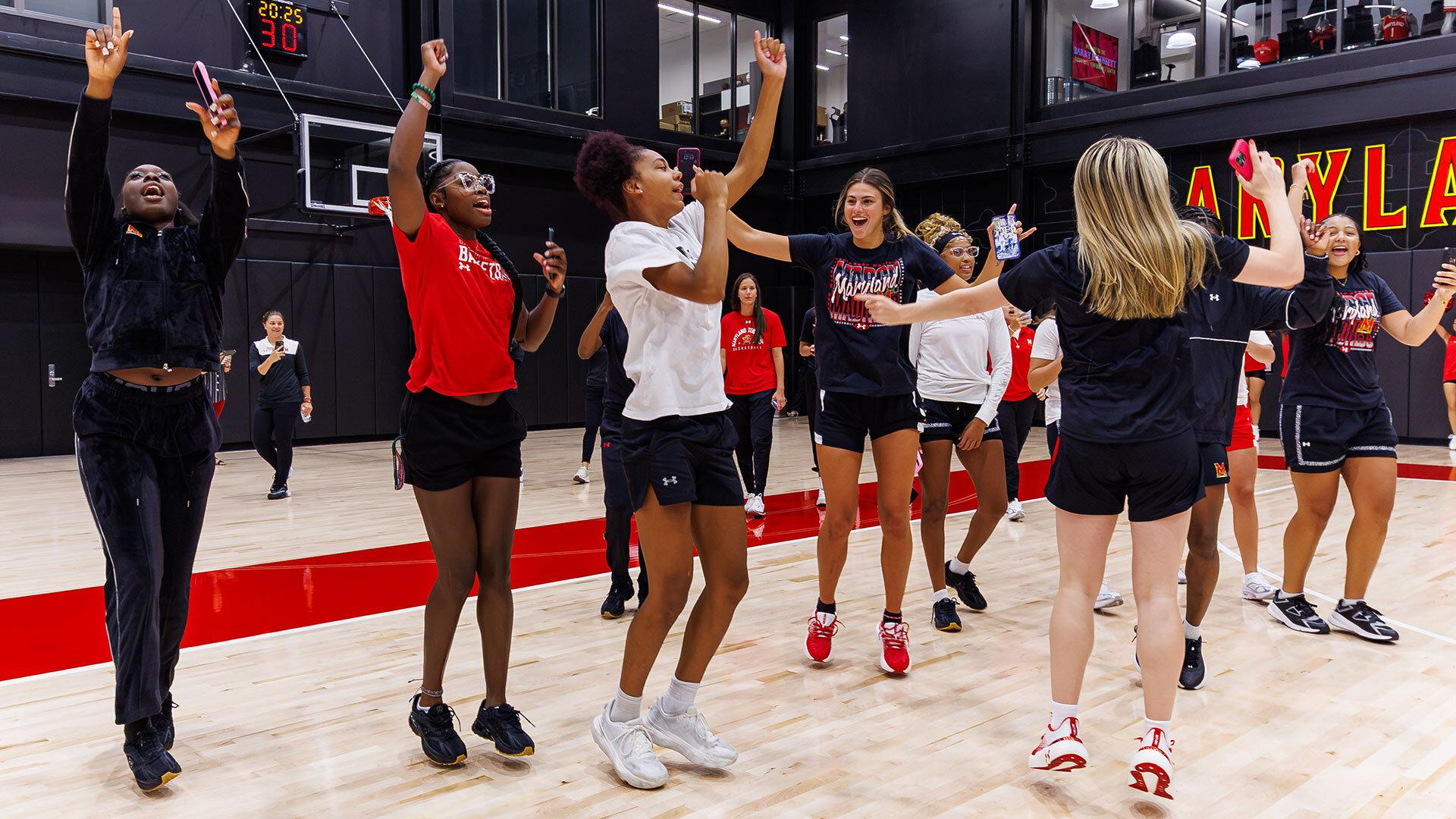 women's basketball team celebrates on practice court