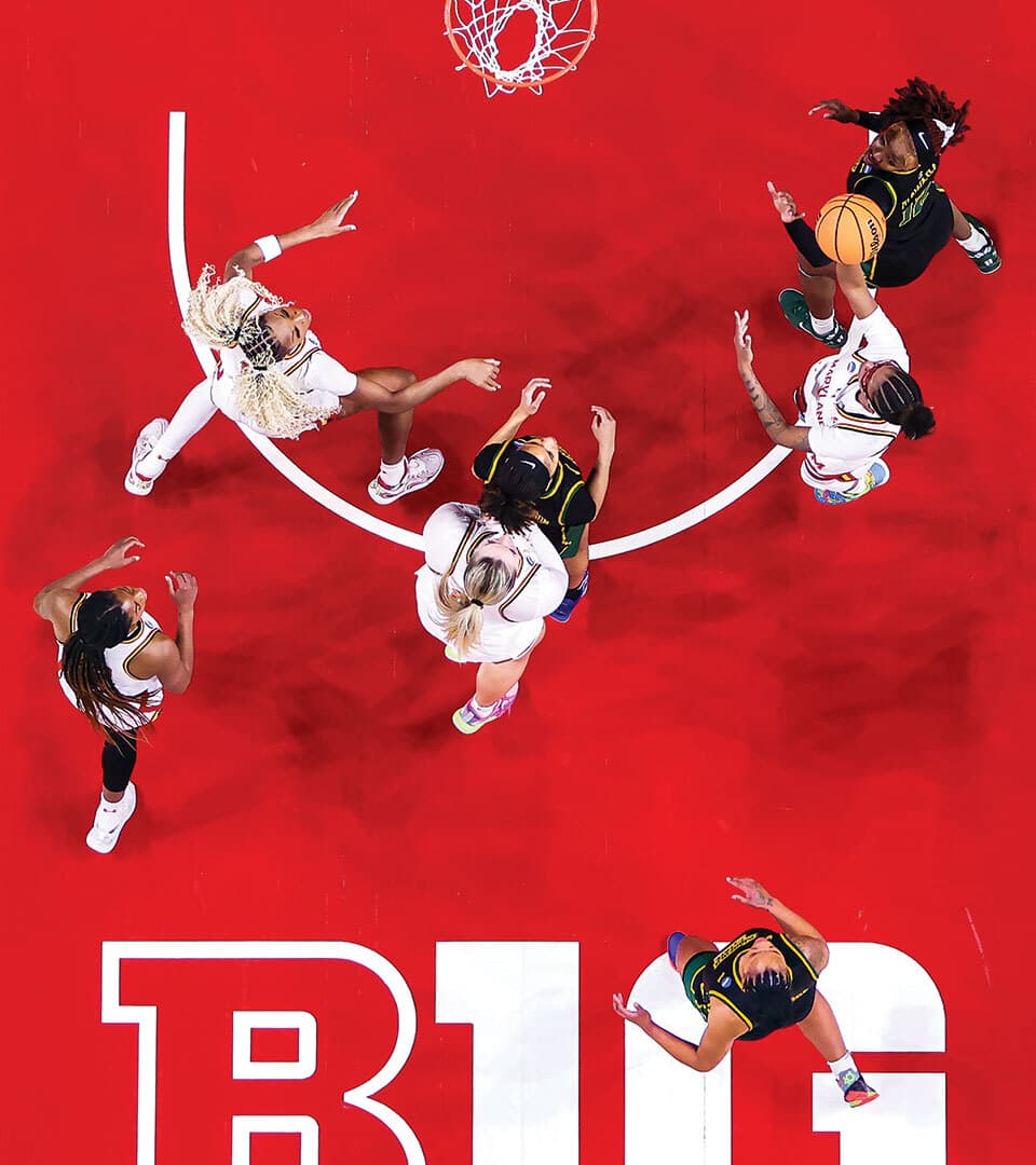overhead view of women's basketball game on red court with Big Ten logo