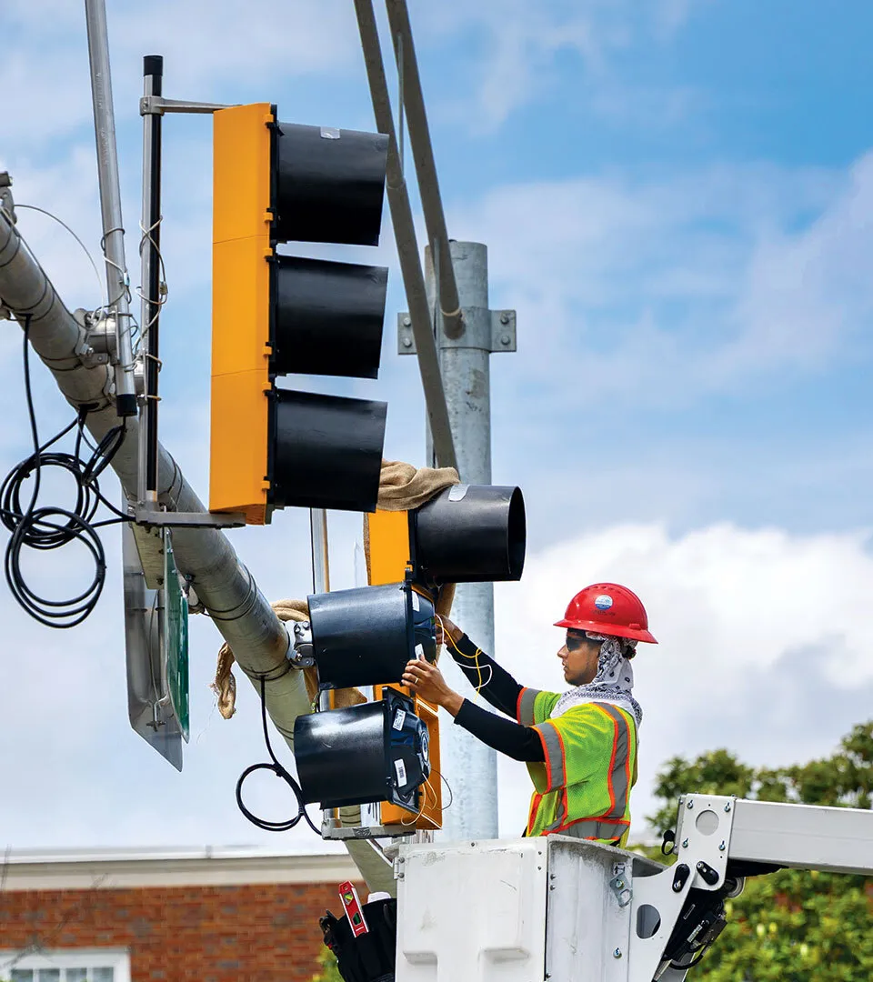 construction worker works on new stoplight