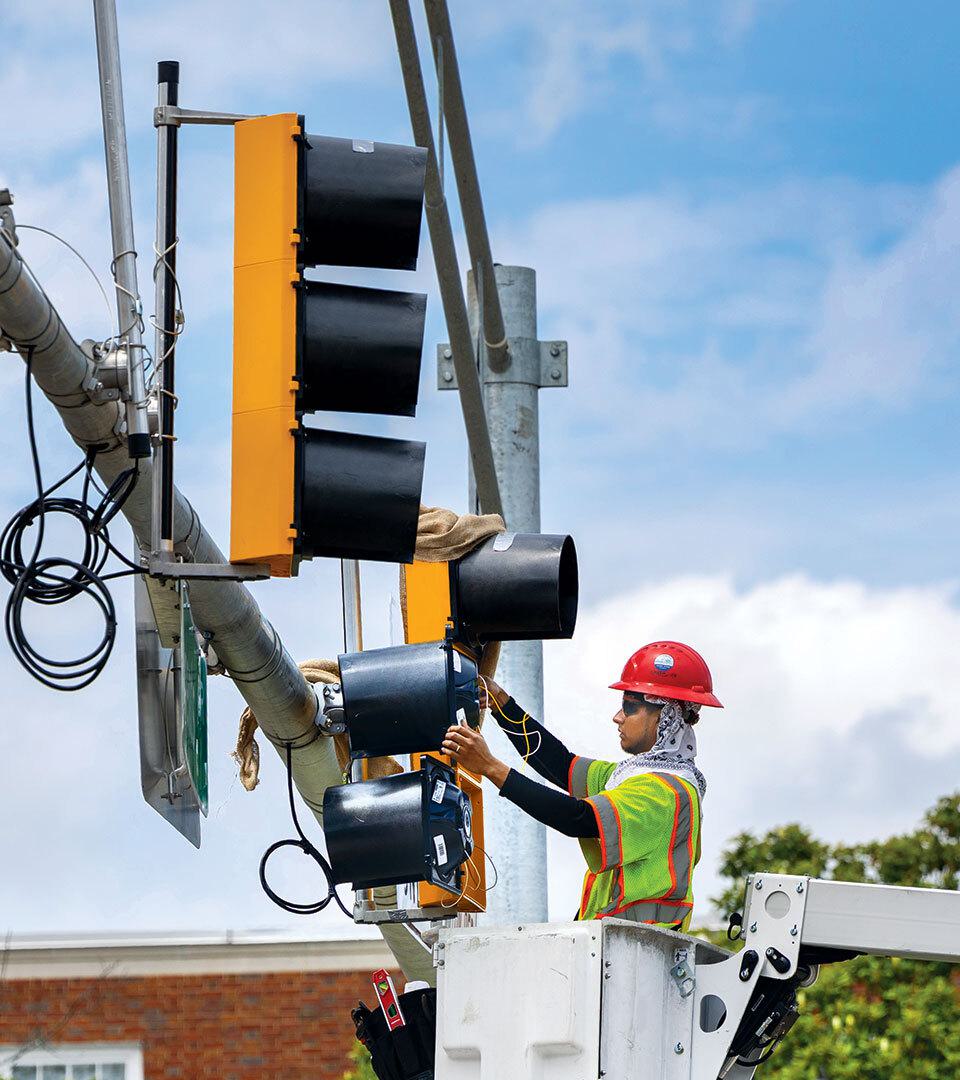 construction worker works on new stoplight