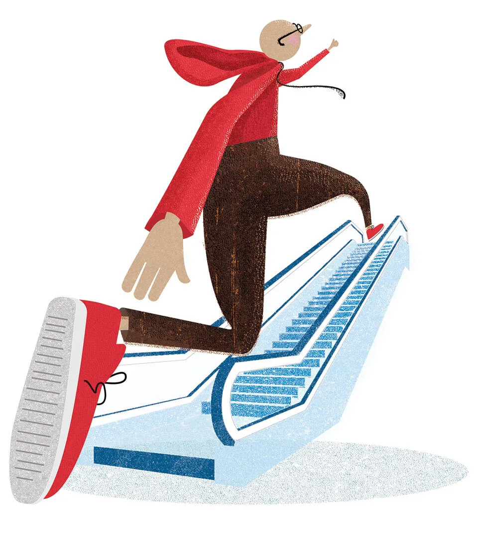 man in red hoodie going up escalator