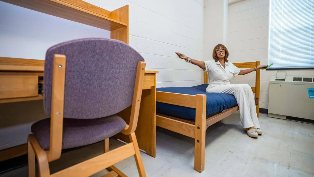 Gayle King sits on bed in dorm