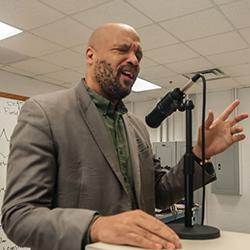 Chance Glenn ’91 sings into microphone