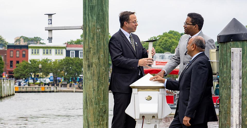 Atmospheric and oceanic science Associate Professor Tim Canty, UMD President Darryll J. Pines and College of Computer, Mathematical, and Natural Sciences Dean Amitabh Varshney discuss the technology behind a newly installed water level sensor