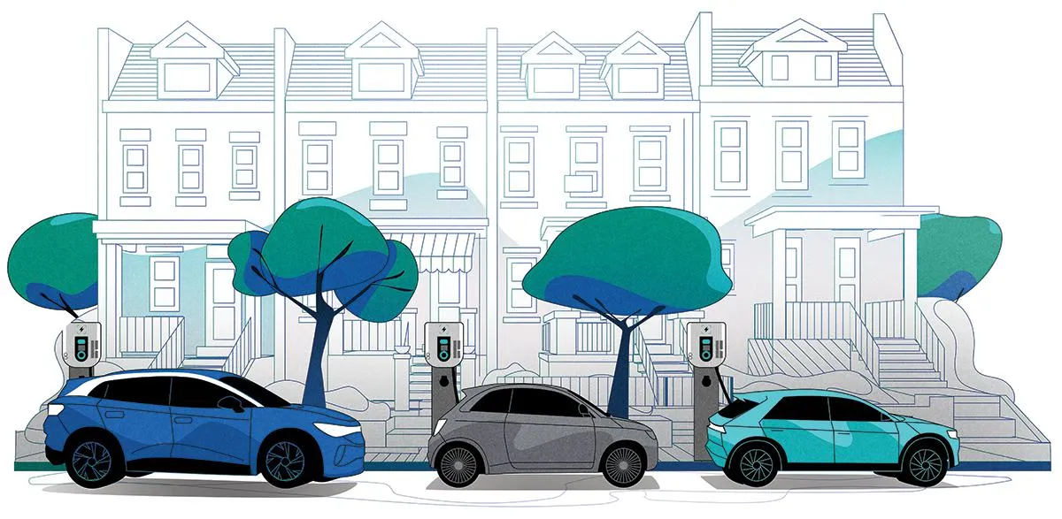 three EVs charging on road outside townhomes