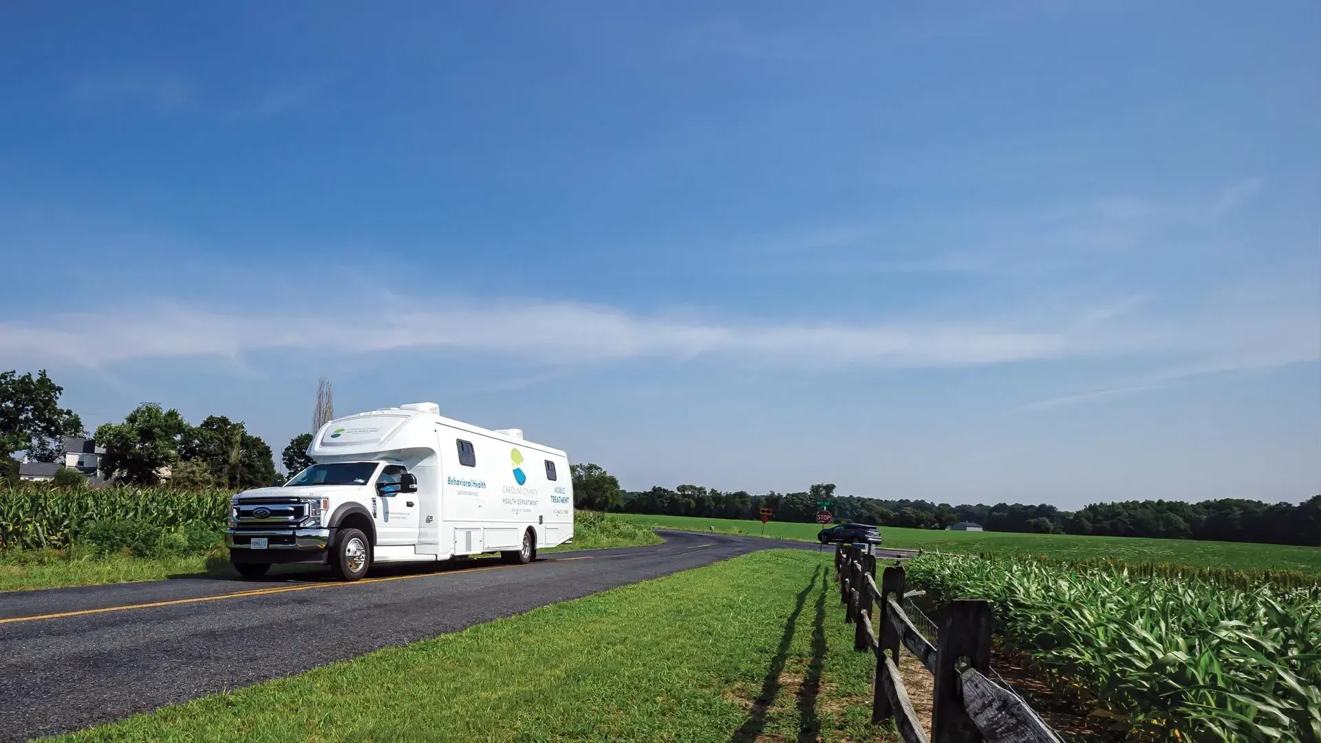A white truck was driving down a country road