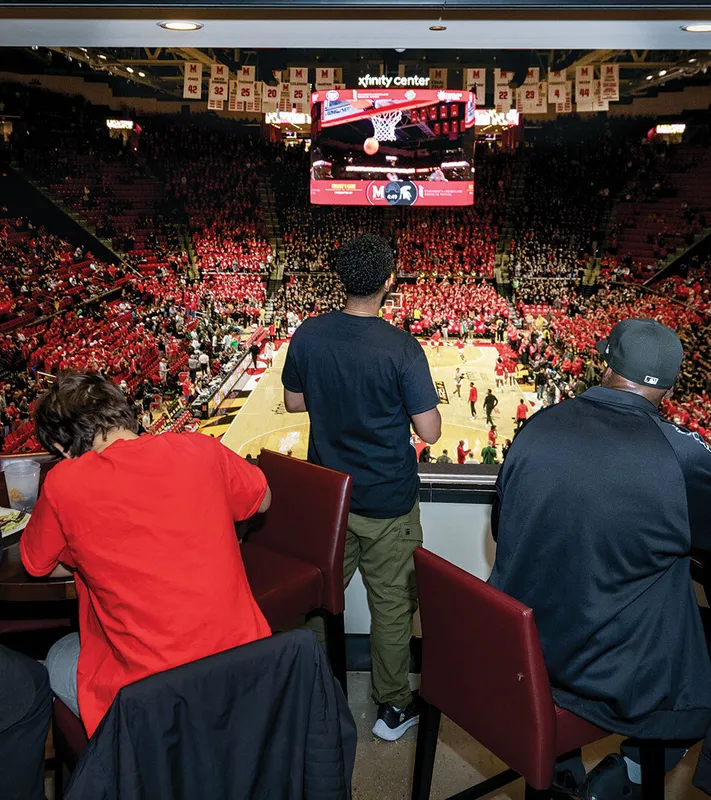 spectators watch UMD basketball game from Maryland Club