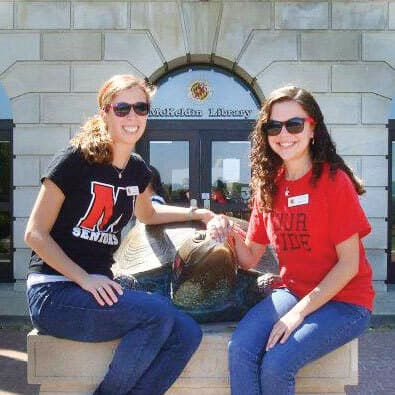 Lisa Berglund ’12 and Corie Sunder ’12 pose by Testudo statue