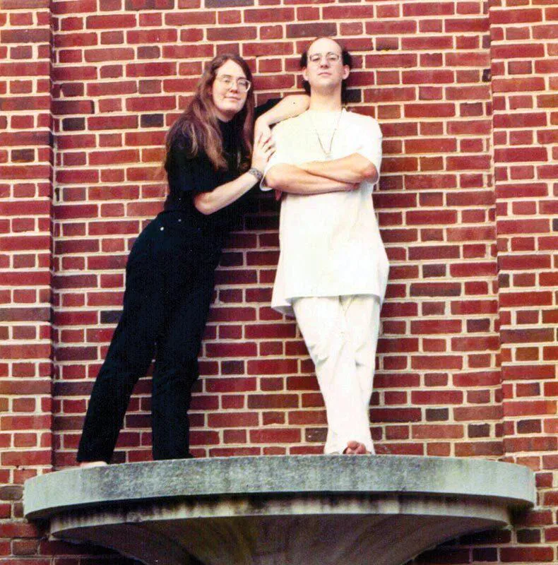 Kristin and Andy Looney pose on a ledge outside the Stamp