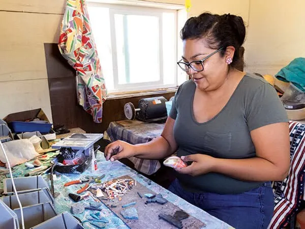 woman makes jewelry