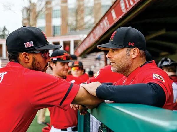 Matt Swope talks to player in dugout