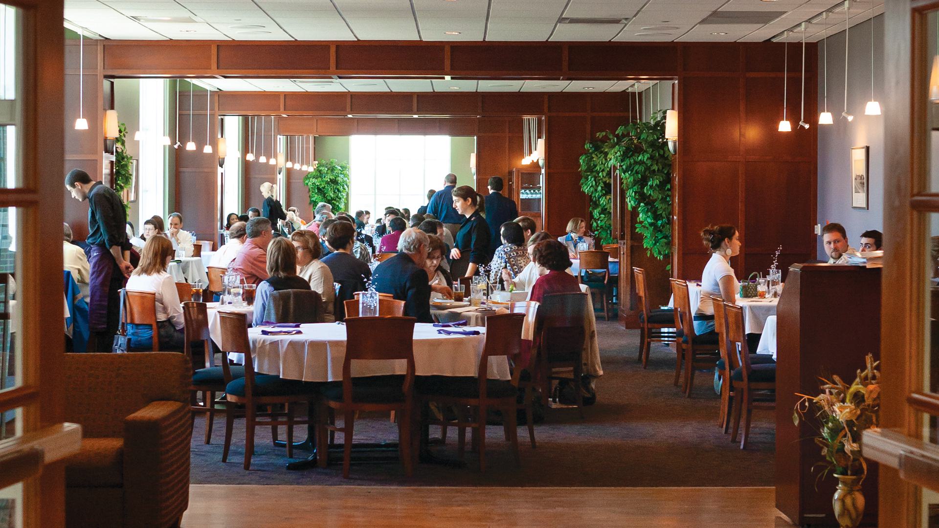 people sit at tables in Adele's restaurant
