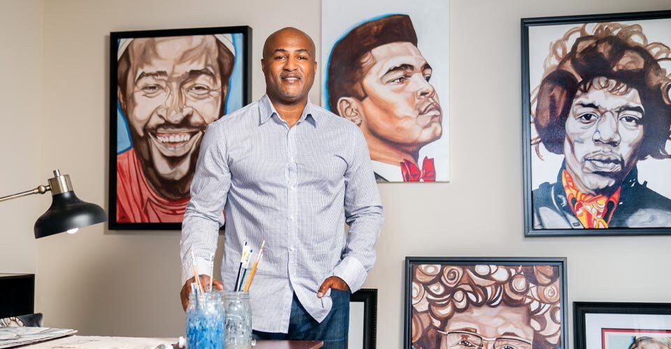 Lynde Washington poses in front of his artwork