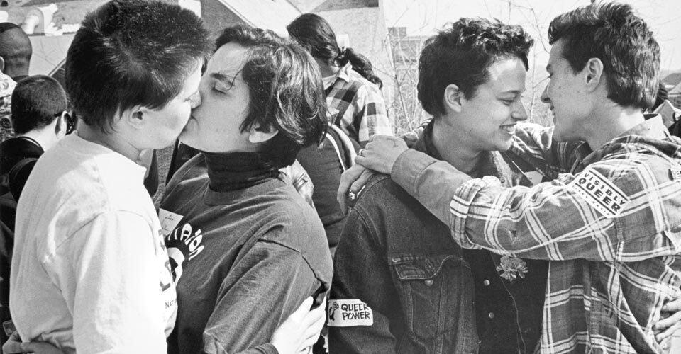 two couples embrace and kiss